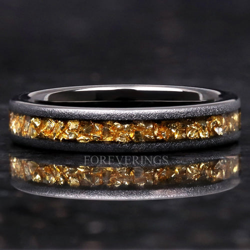 4mm sandblasted black tungsten band with crushed citrine inlay, lying flat with reflection