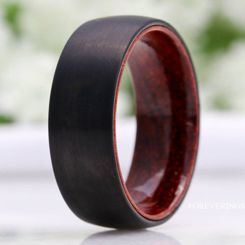 Men's 8mm black tungsten wedding band with rosewood lining, standing at an angle
