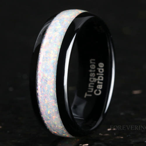 Men's 8mm black tungsten wedding ring with white fire opal inlay, standing at an angle