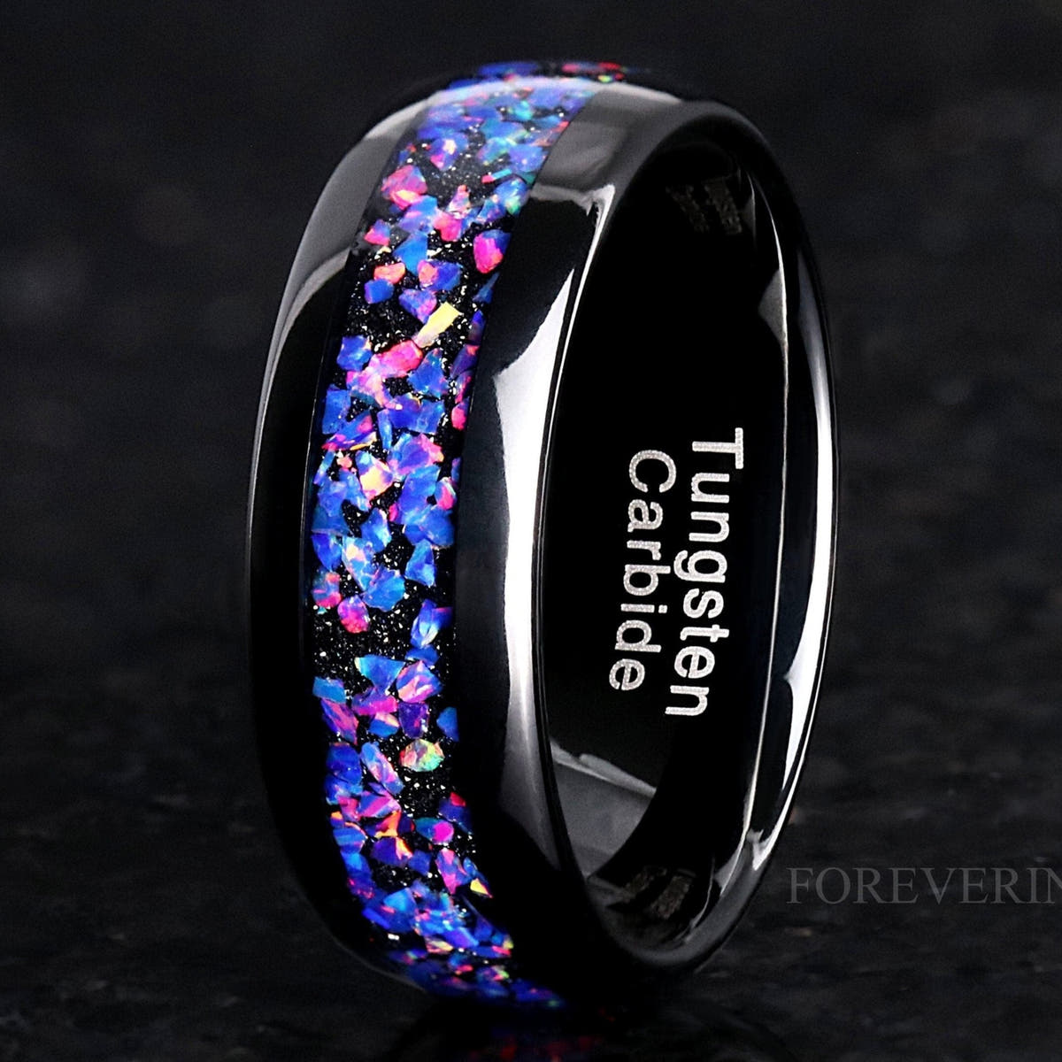 Men's 8mm black tungsten wedding band with crushed Van Gogh opal inlay, angled close view