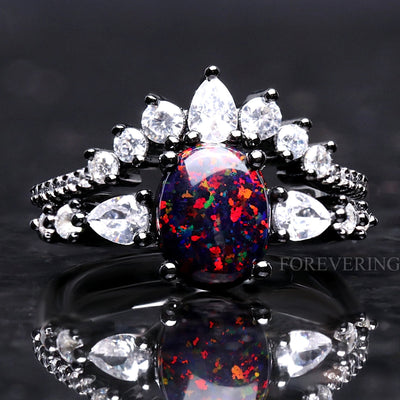 Women's vintage black fire opal bridal set in black sterling silver with white pear side stones