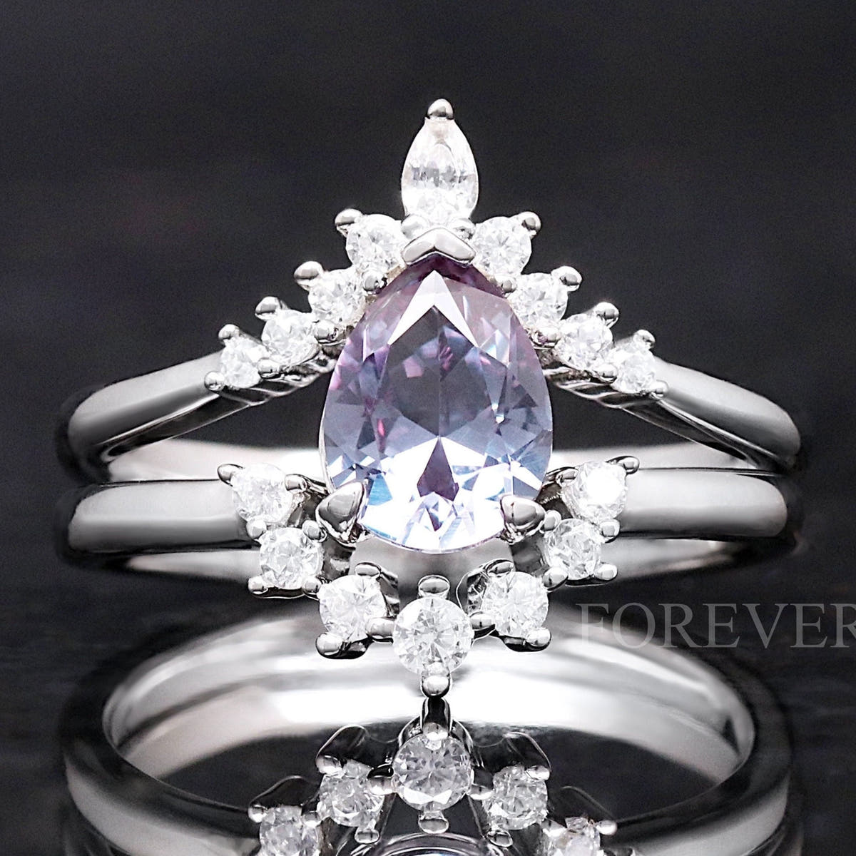 Sterling silver alexandrite bridal set with a pear-cut stone and curved accent bands