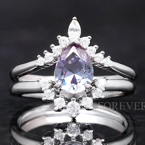 Sterling silver alexandrite bridal set with a pear-cut stone and curved accent bands