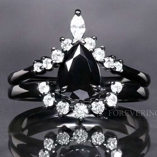 Women's black onyx bridal set: pear-cut engagement ring nested with a curved band of white stones