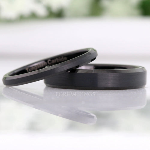 Minimalist matte black tungsten rings in two widths, the thinner leaning on the wider