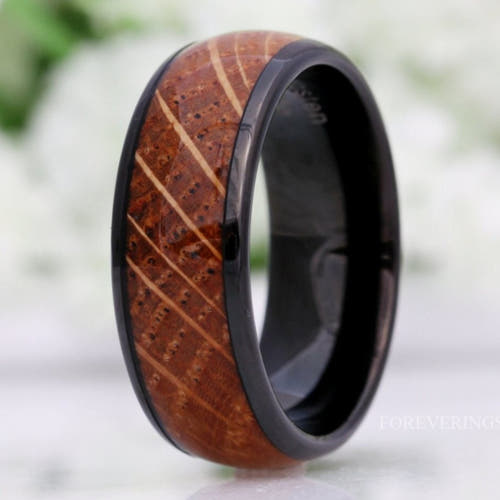 Men's 8mm black tungsten wedding band with whiskey barrel wood inlay, polished dome, standing upright