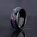 Men's 8mm black tungsten wedding band with supernova-inspired galaxy inlay, standing at an angle