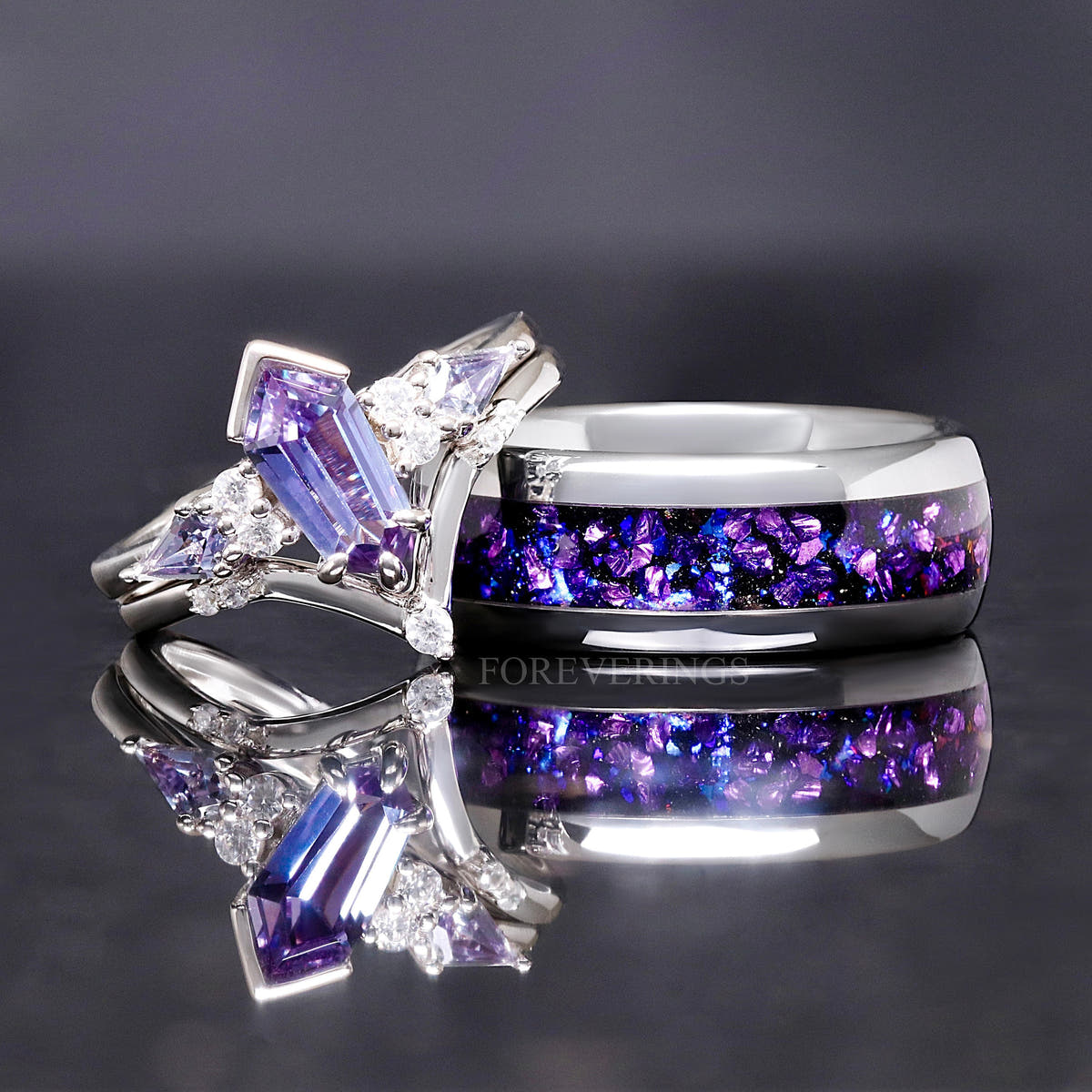 Alexandrite engagement ring set beside a wider silver band with crushed purple inlay