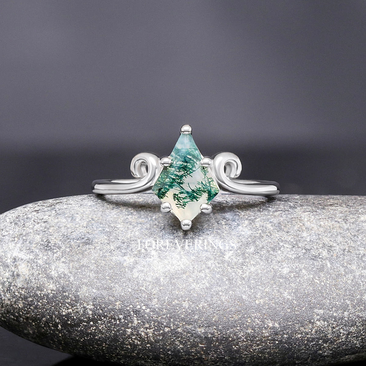 Women's sterling silver kite-cut moss agate ring with a twirl scroll band, shown straight on