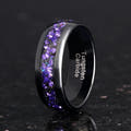 Men's 8mm black tungsten band with alexandrite and purple sandstone inlay, standing on edge