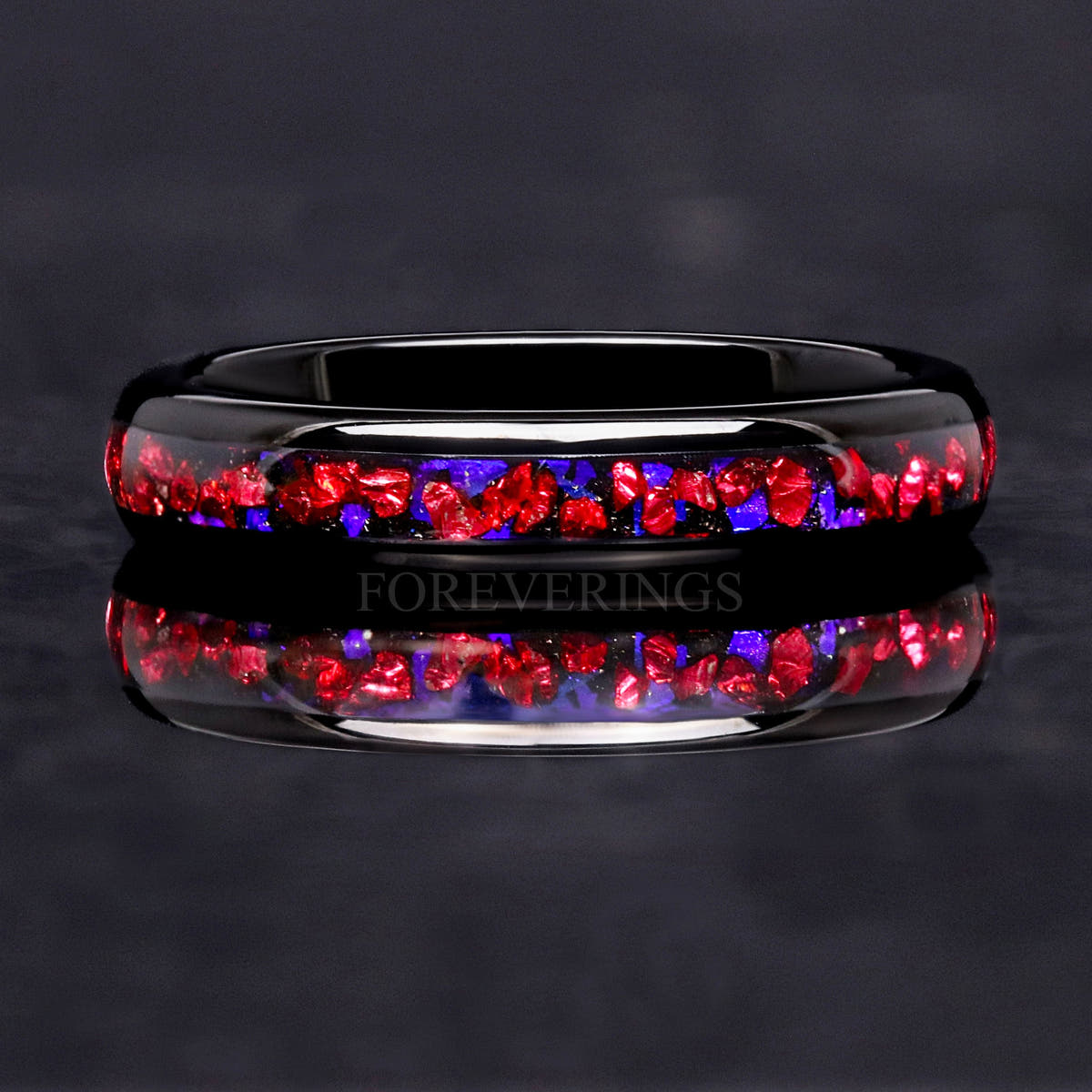 4mm black tungsten band lying flat, front view of the crushed ruby and blue sandstone inlay