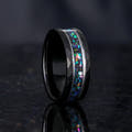 Men's 8mm black and silver tungsten wedding band with nebula-inspired crushed stone inlay, standing angled
