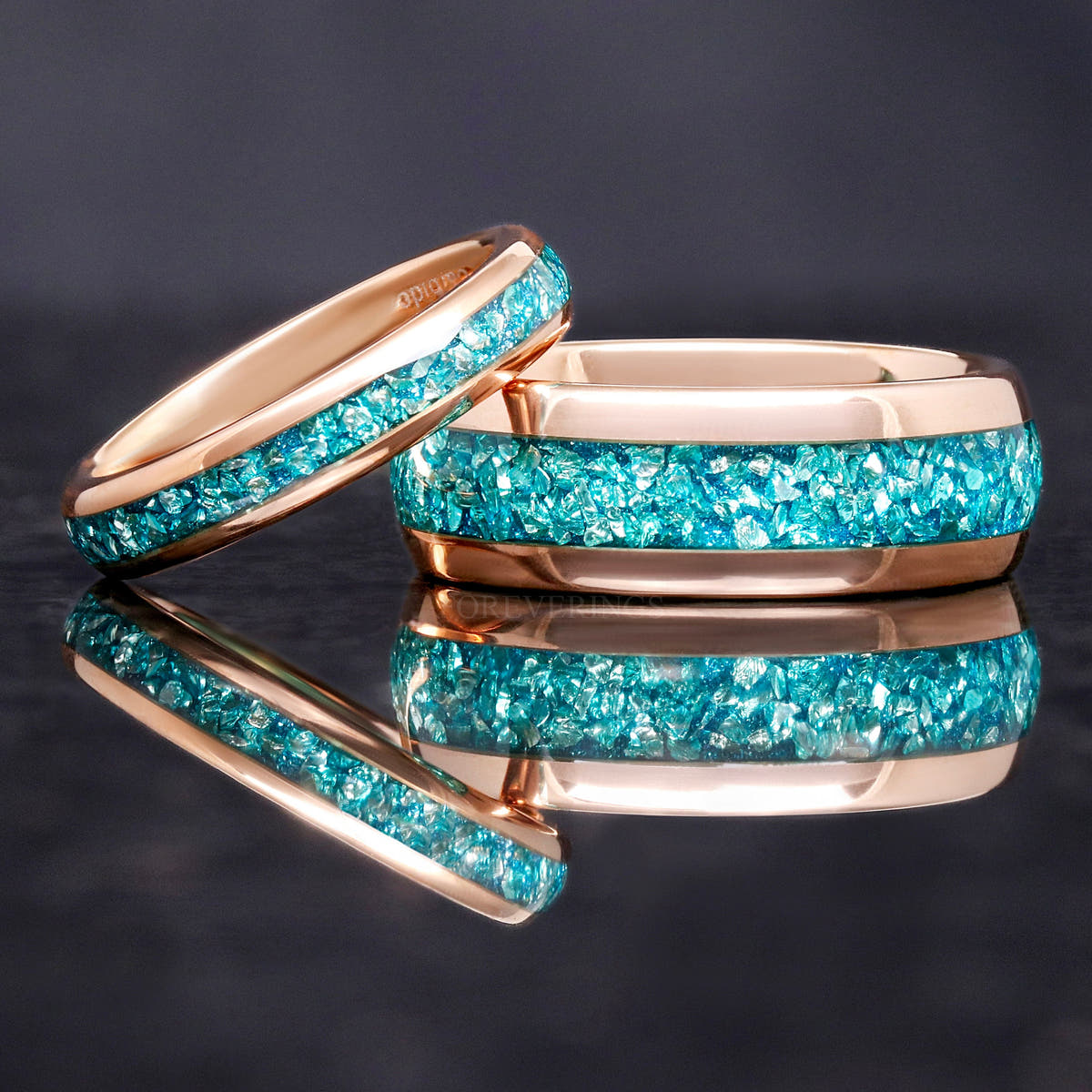 Rose gold tungsten aquamarine bands, a narrow ring leaning on the 8mm band
