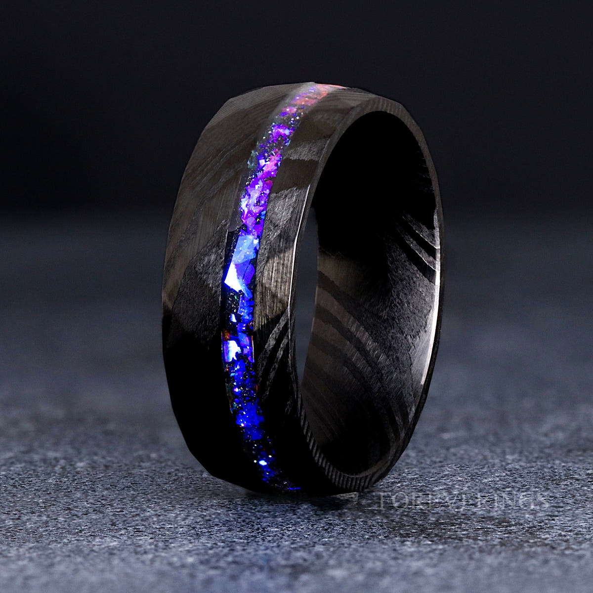 Men's 8mm black Damascus steel band with Orion nebula sandstone inlay, standing upright