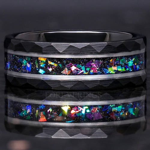 Men's 8mm hammered black tungsten band with silver lines and supernova-inspired crushed stone inlay, lying flat
