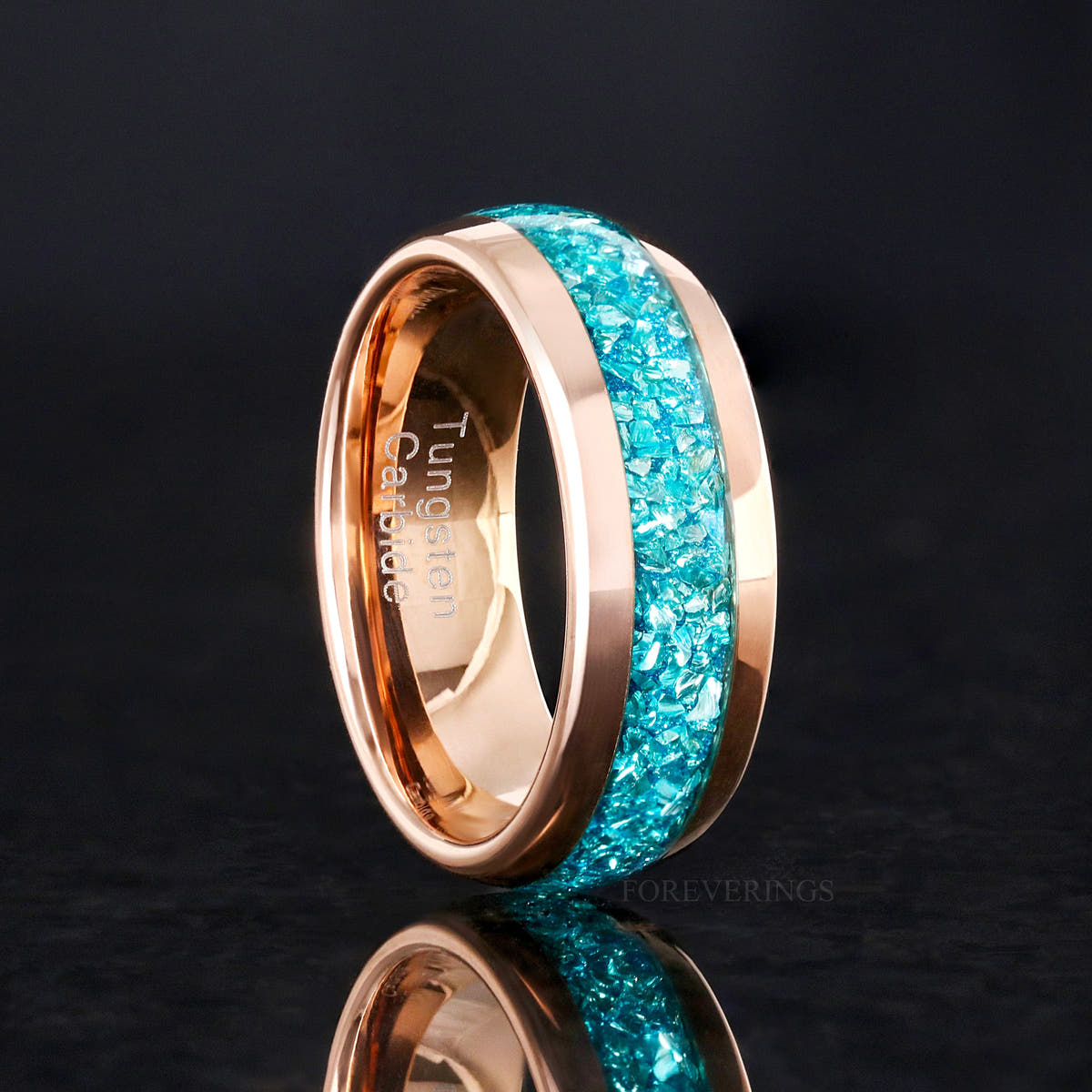 Crushed aquamarine band in rose gold tungsten standing on edge, wider angled view