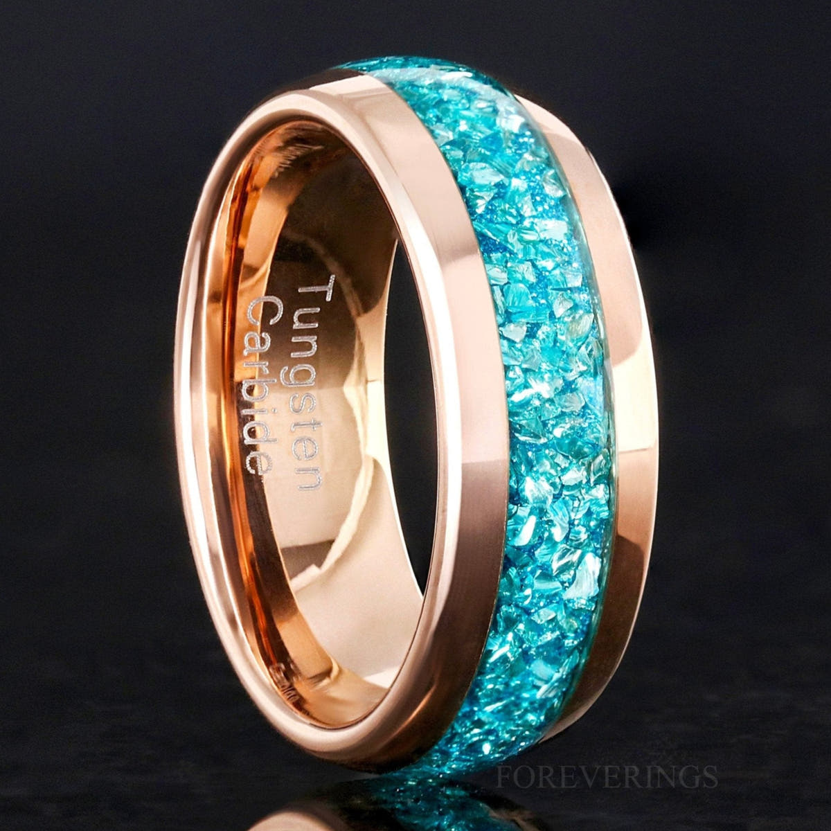 Men's 8mm rose gold tungsten band with crushed aquamarine inlay, standing close-up