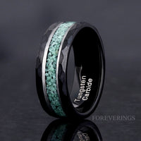 Men's 8mm hammered black tungsten ring with crushed moss agate inlay and a silver stripe, angled