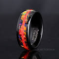 Men's 8mm black tungsten ring with a crushed red fire opal stripe over dichrolam, standing at an angle