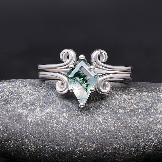 Sterling silver moss agate engagement ring with swirl details and a curved band, straight on