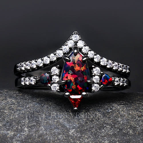 Women's black sterling silver shield-cut black fire opal engagement ring with a curved band, close crop