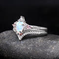 White opal bridal set in sterling silver, angled to show the pink side stones