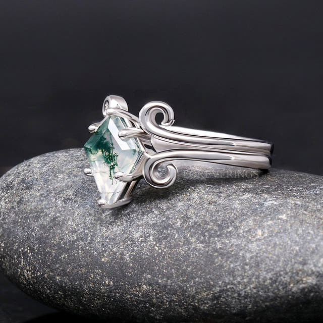 Kite-cut moss agate ring in sterling silver, angled side view of the scrolled band