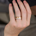 8mm matte rose gold tungsten band with a white opal edge strip worn on a hand