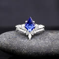 Women's sterling silver bridal set with a kite-cut blue sapphire and curved band, front view