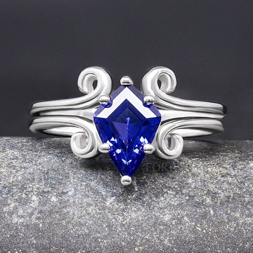 Women's sterling silver kite-cut sapphire bridal set with a curved twirl band, shown straight on