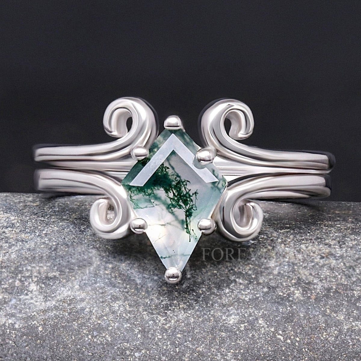 Women's kite-cut moss agate ring on a twirling sterling silver band, shown straight on