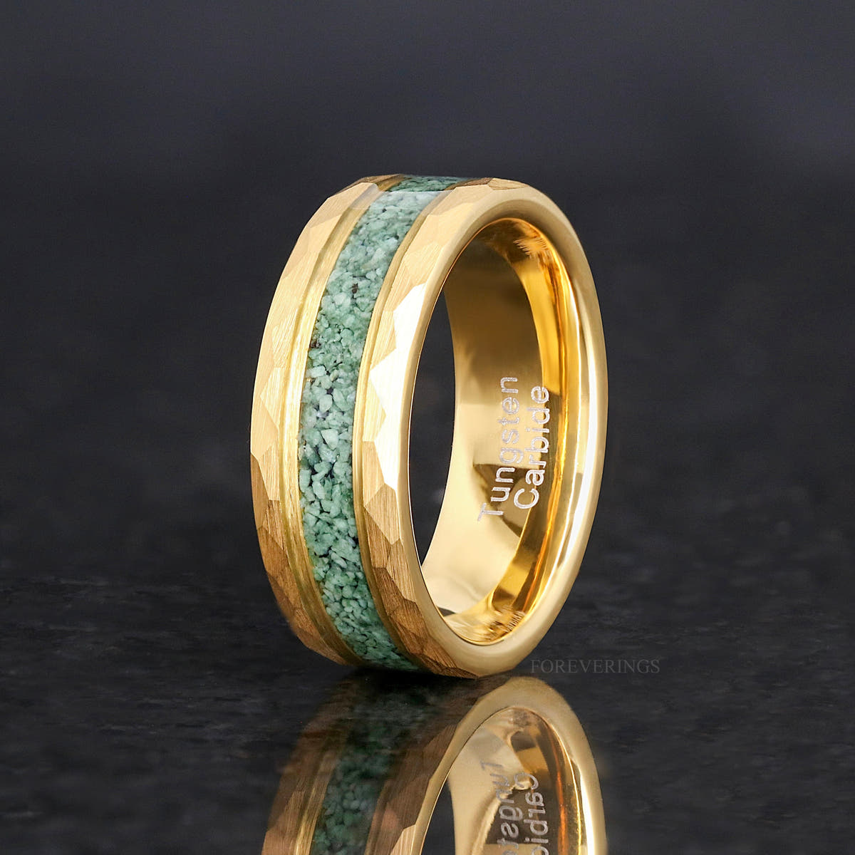 Men's 8mm gold hammered tungsten band with green moss agate inlay, standing on edge