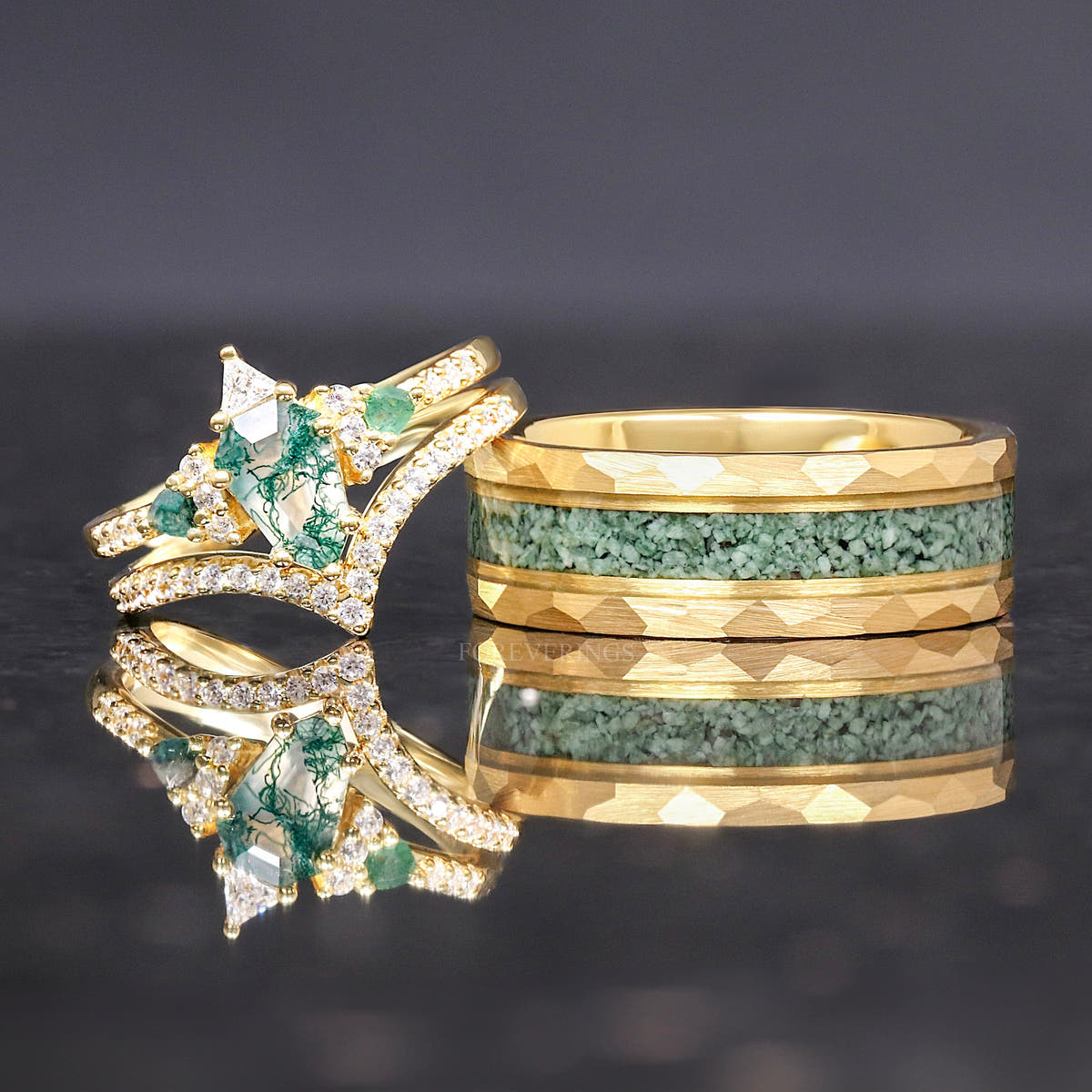 Gold moss agate tungsten ring with a gold engagement ring and curved band leaning on it