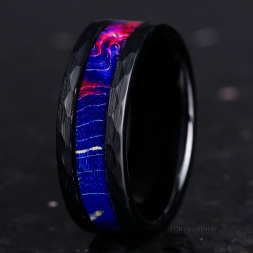 Men's 8mm hammered black tungsten ring with blue elder wood inlay, standing on edge