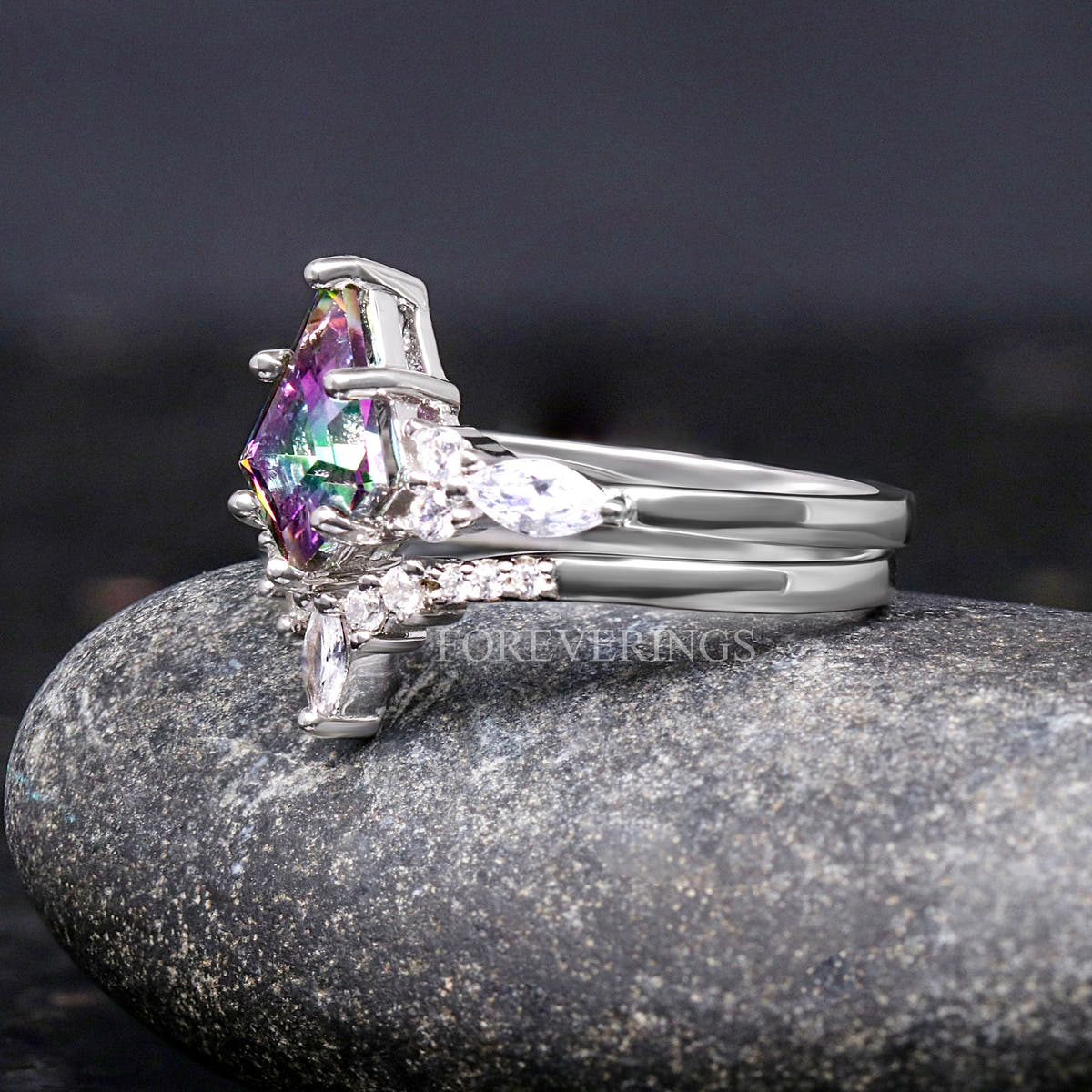 Sterling silver mystic topaz engagement ring and curved band, angled side view