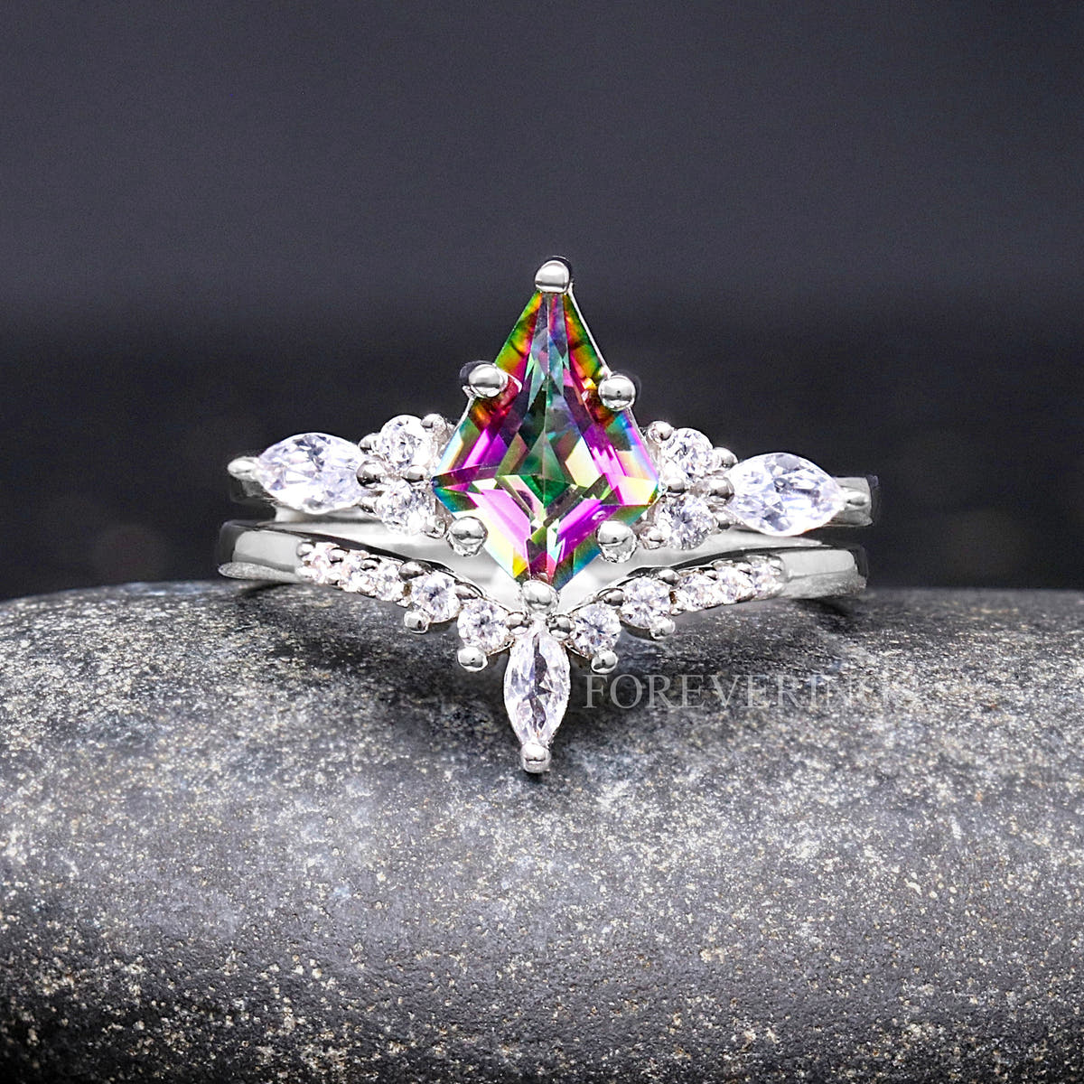 Women's sterling silver bridal set with a kite-cut mystic topaz and marquise side stones, straight on