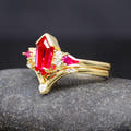 Gold ruby engagement ring nested in a curved band, angled side view