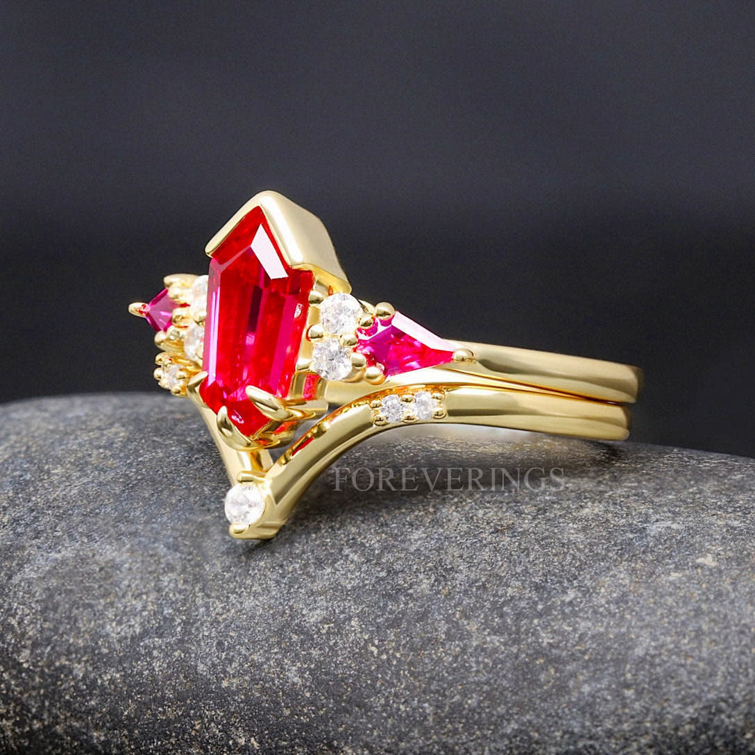 Gold ruby engagement ring nested in a curved band, angled side view