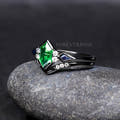 Tsavorite engagement ring and curved band in black sterling silver, angled side view