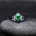 Women's black sterling silver engagement ring set with a hexagon tsavorite and blue side stones, front view