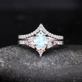 Women's sterling silver white opal engagement ring with pink side stones and curved band, front view