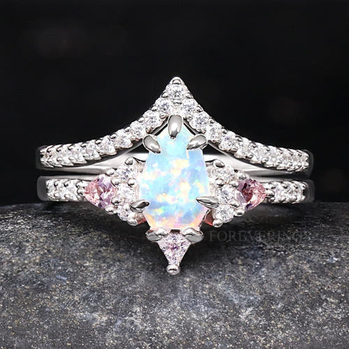 White opal bridal set in sterling silver with pink morganite side stones and a curved band, front view