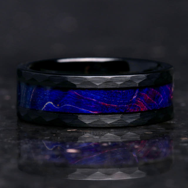 8mm hammered black tungsten blue elder wood band lying flat, seen straight on with reflection below
