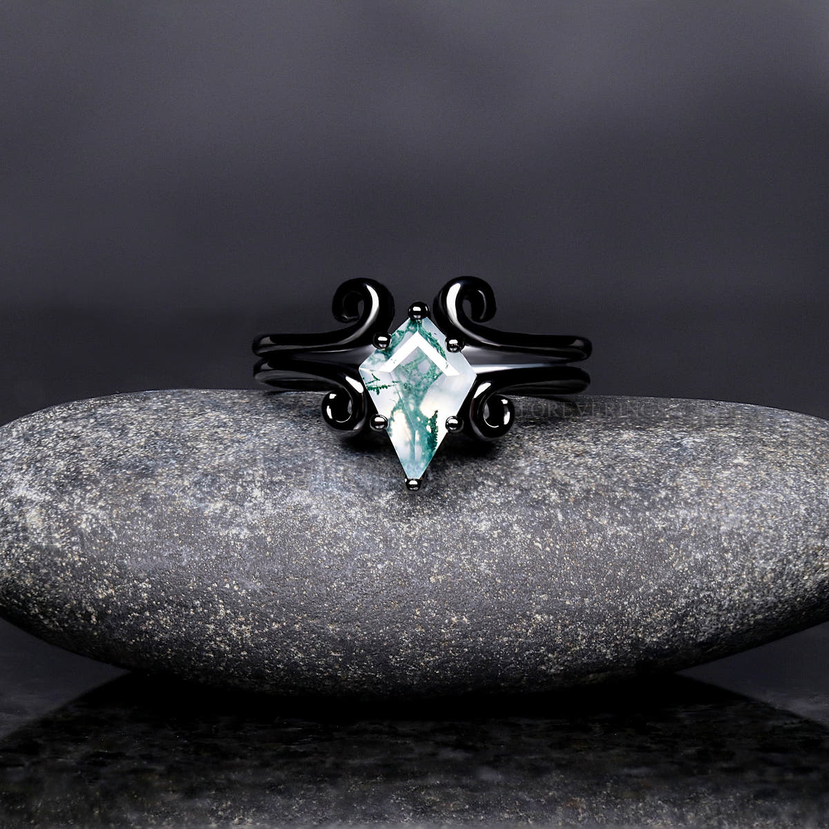 Black sterling silver moss agate ring shown straight on in a wider view