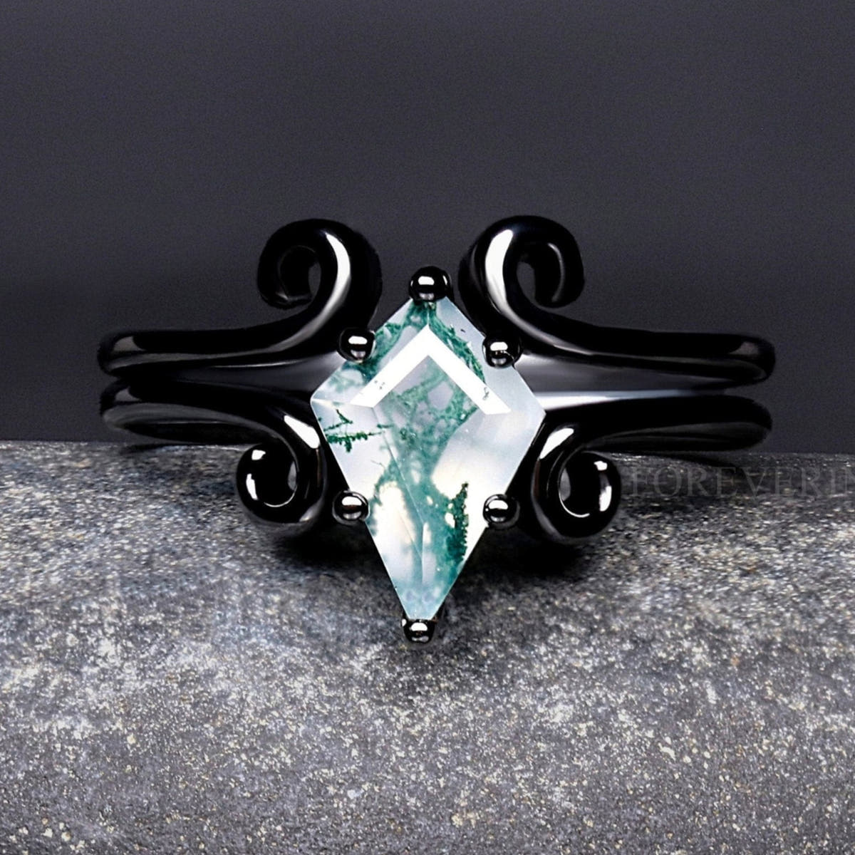 Women's black sterling silver kite cut moss agate ring with swirl details, close-up