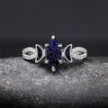 Sterling silver crescent moon ring with a marquise blue sandstone, shown straight on
