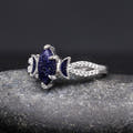 Sterling silver marquise blue sandstone ring with stone-lined band, angled side view