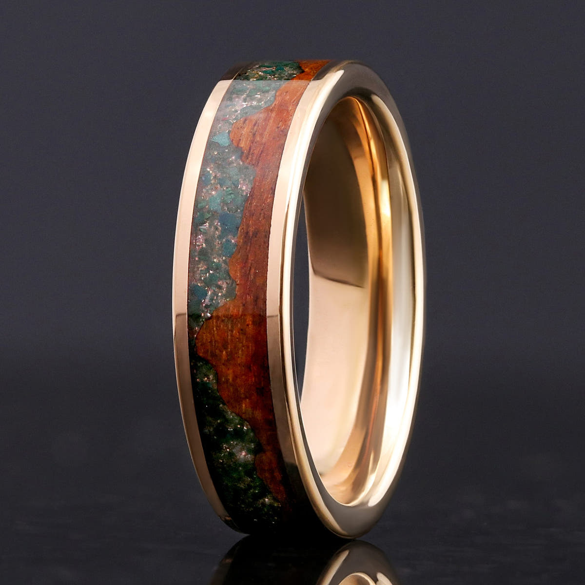 Men's 6mm rose gold tungsten ring with moss agate and koa wood inlay, angled to show the interior