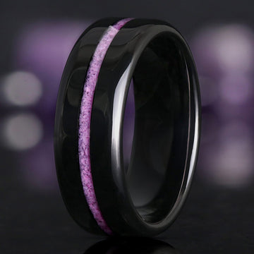 Men's 8mm black tungsten wedding band with a crushed purple turquoise inlay, standing at an angle