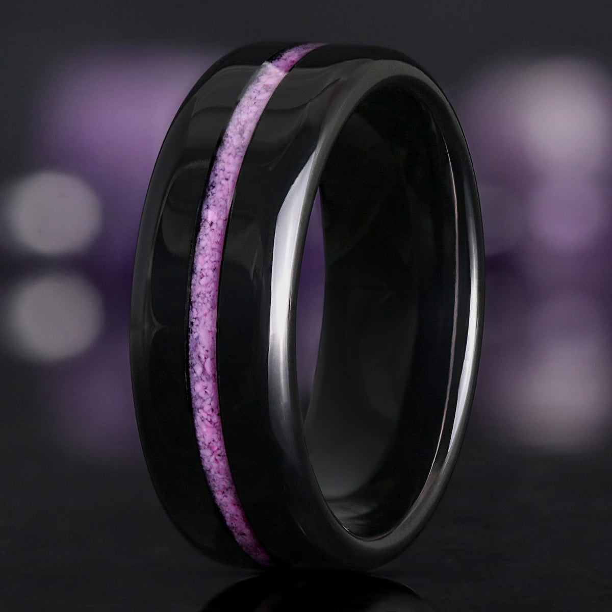 Men's 8mm black tungsten wedding band with a crushed purple turquoise inlay, standing at an angle
